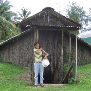 Mana's mother outside the mushroom hut in Samoa